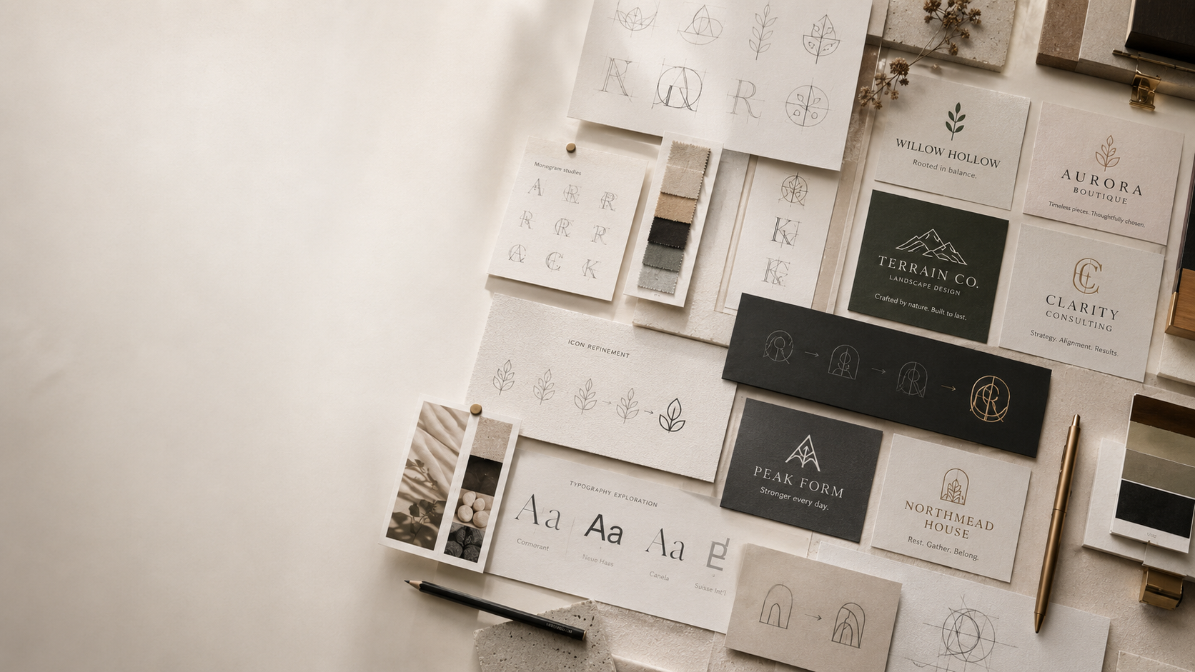 Minimal branding workspace showing logo sketches, typography studies, color swatches, and refined logo and tagline concepts laid out on a design table.